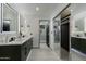 Bright bathroom features a double vanity with framed mirrors and a glass shower enclosure at 7721 N Via De La Montana --, Scottsdale, AZ 85258