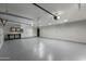 Large three car garage with epoxy floors, storage cabinets, workbench, and painted walls at 7721 N Via De La Montana --, Scottsdale, AZ 85258