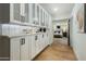 Hallway features custom built-in cabinets, a counter, and opens to a bedroom with hardwood floors at 7721 N Via De La Montana --, Scottsdale, AZ 85258