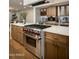 Gourmet kitchen with stainless steel Wolf range, custom cabinets, and white countertops at 7721 N Via De La Montana --, Scottsdale, AZ 85258