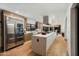 Spacious open kitchen with large island, stainless steel appliances, and wood floors at 7721 N Via De La Montana --, Scottsdale, AZ 85258