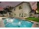 Backyard view featuring a sparkling pool, patio area, lush lawn, and mature trees at 7721 N Via De La Montana --, Scottsdale, AZ 85258