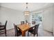 Cozy dining room with a rustic wood table set and a sliding glass door leading to the patio at 9021 E Palmer Dr, Sun Lakes, AZ 85248