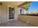 Private balcony with access door, stucco walls, and clear sky view at 9990 N Scottsdale Rd # 2049, Paradise Valley, AZ 85253