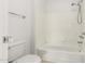 Bright bathroom features a tub and shower combination and tiled walls at 9990 N Scottsdale Rd # 2049, Paradise Valley, AZ 85253