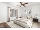 Bedroom with plush carpet, ceiling fan, and large window at 9990 N Scottsdale Rd # 2049, Paradise Valley, AZ 85253