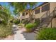 Charming apartment building with well-maintained landscaping, stairs leading to entry, and warm desert colors at 9990 N Scottsdale Rd # 2049, Paradise Valley, AZ 85253