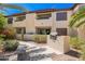 Building featuring an outdoor grill, seating area, and landscaping at 9990 N Scottsdale Rd # 2049, Paradise Valley, AZ 85253