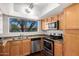 Well-equipped kitchen with stainless steel appliances, wood cabinets, and a view to the outdoors at 9990 N Scottsdale Rd # 2049, Paradise Valley, AZ 85253
