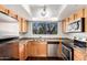 Efficient kitchen featuring stainless steel appliances, wood cabinets, and a bright window at 9990 N Scottsdale Rd # 2049, Paradise Valley, AZ 85253