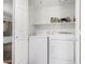 Laundry room featuring stacked washer and dryer with storage space at 9990 N Scottsdale Rd # 2049, Paradise Valley, AZ 85253