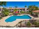 Community pool featuring lounge chairs, lush landscaping, and a clear blue swimming area at 9990 N Scottsdale Rd # 2049, Paradise Valley, AZ 85253