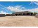 Backyard featuring a large building, neutral landscape, block wall and a blue sky at 10203 N Burris Rd, Casa Grande, AZ 85122