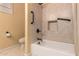 Accessible bathroom with tub, grab bars, and tile surround at 10203 N Burris Rd, Casa Grande, AZ 85122