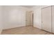 Neutral bedroom featuring wood floors with a closet and view to another room at 10203 N Burris Rd, Casa Grande, AZ 85122