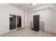 Bright hallway featuring neutral paint, tile floors, a sliding glass door and a brown front door at 10203 N Burris Rd, Casa Grande, AZ 85122