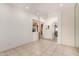 Bright living room with neutral paint, tile floors, and arched doorway at 10203 N Burris Rd, Casa Grande, AZ 85122