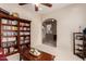 Cozy living room featuring a bookshelf, a ceiling fan and an arched doorway at 10203 N Burris Rd, Casa Grande, AZ 85122