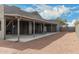 A large outdoor patio with a gravel path, neutral landscape, and covered lounge area at 10203 N Burris Rd, Casa Grande, AZ 85122