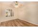 Bedroom featuring an arched window, ceiling fan, and wood-style flooring creating a cozy atmosphere at 10339 E Juanita Ave, Mesa, AZ 85209