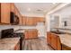 Well-lit kitchen featuring wooden cabinetry, modern appliances, and sleek countertops at 10339 E Juanita Ave, Mesa, AZ 85209