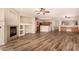 Inviting living room with fireplace open to the kitchen and dining area, showcasing modern flooring at 10339 E Juanita Ave, Mesa, AZ 85209