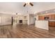 Open-concept living room featuring wood-look flooring, a fireplace, and plenty of natural light at 10339 E Juanita Ave, Mesa, AZ 85209