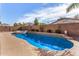 Backyard showcases sparkling private pool with spa, desert landscaping, and block wall at 10339 E Juanita Ave, Mesa, AZ 85209