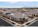 Aerial view of the property showcases the home's setting within a neighborhood, highlighting its landscaping and roof at 10702 E Sheffield Dr, Mesa, AZ 85212