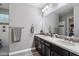 Bright bathroom featuring double sinks with modern fixtures and an elegant mirror at 10702 E Sheffield Dr, Mesa, AZ 85212