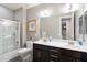 Bathroom featuring shower over tub, double sink vanity, and stylish nautical decor at 10702 E Sheffield Dr, Mesa, AZ 85212