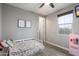 Calm bedroom with a twin bed, floral bedding, and a serene window view at 10702 E Sheffield Dr, Mesa, AZ 85212