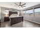 Serene primary bedroom featuring wood-look tile floors, neutral walls, and generous natural light at 10702 E Sheffield Dr, Mesa, AZ 85212