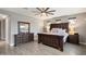 Well-lit primary bedroom showcases wood-look tile floors, neutral walls, and a large window at 10702 E Sheffield Dr, Mesa, AZ 85212