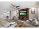 Bright living room featuring wood-look floors, modern décor, and a large TV mounted on a wood wall at 10702 E Sheffield Dr, Mesa, AZ 85212