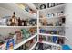 Walk-in pantry with ample shelving to keep all your dry goods and kitchen essentials organized at 10702 E Sheffield Dr, Mesa, AZ 85212