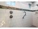 Walk-in shower featuring white subway tile with a decorative accent strip and dual shower heads at 10702 E Sheffield Dr, Mesa, AZ 85212