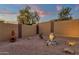 Desert landscaping with gravel, cactus, and custom lighting in this private backyard at 10758 E Peralta Canyon Dr, Gold Canyon, AZ 85118