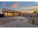 Home exterior with covered patio, brick pavers, desert landscaping, and block fence at 10758 E Peralta Canyon Dr, Gold Canyon, AZ 85118