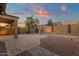 Covered patio with brick pavers, desert landscaping, and block wall in this private backyard at 10758 E Peralta Canyon Dr, Gold Canyon, AZ 85118