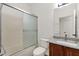 Bright bathroom with granite counters, modern lighting, and a shower with sliding glass doors at 10758 E Peralta Canyon Dr, Gold Canyon, AZ 85118