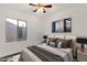 This bedroom features a ceiling fan, a window, and a comfortable bed with stylish throw pillows at 10758 E Peralta Canyon Dr, Gold Canyon, AZ 85118