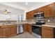 Close up of kitchen with stainless steel appliances, wood cabinetry, and mosaic backsplash at 10758 E Peralta Canyon Dr, Gold Canyon, AZ 85118