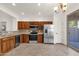 Bright kitchen with stainless steel appliances, wood cabinetry, and sliding glass doors at 10758 E Peralta Canyon Dr, Gold Canyon, AZ 85118