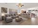 Inviting living room featuring a stylish sofa and open-concept layout to the kitchen and dining area at 10758 E Peralta Canyon Dr, Gold Canyon, AZ 85118