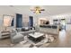 Bright living room boasts a modern sectional sofa, stylish coffee table, and inviting open-concept design at 10758 E Peralta Canyon Dr, Gold Canyon, AZ 85118