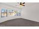 Neutral main bedroom with large windows and ceiling fan at 10758 E Peralta Canyon Dr, Gold Canyon, AZ 85118