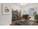 Bright home office with a wooden desk, shelving unit, and natural light at 10758 E Peralta Canyon Dr, Gold Canyon, AZ 85118