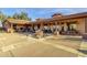 Inviting outdoor patio with seating, a fireplace, a water feature, and covered dining at 10758 E Peralta Canyon Dr, Gold Canyon, AZ 85118