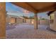 A covered patio features decorative desert landscaping and a stunning sunset backdrop at 10758 E Peralta Canyon Dr, Gold Canyon, AZ 85118